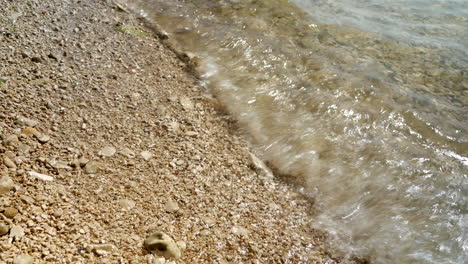 close-up of many waves ending on the pebble beach in croatia