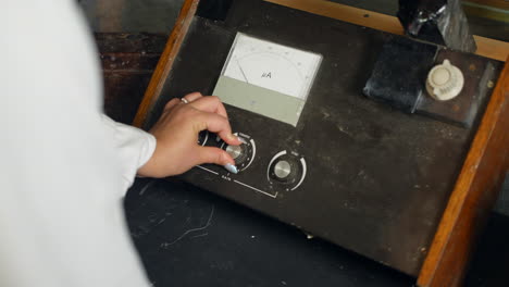 a female scientist using a vintage fluorometer