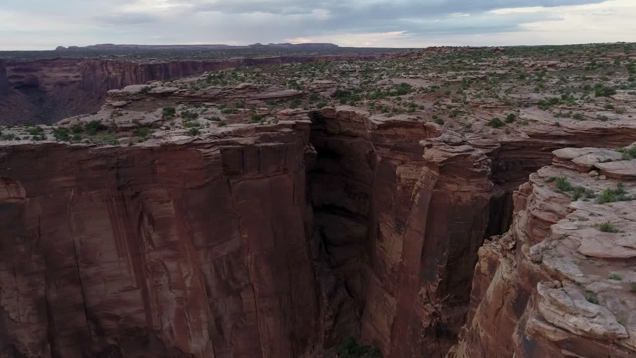 A 4K rotating drone shot of the "Fruit Bowl", a famous highlining area found deep in the heart of Moab’s share of the Colorado Plateau, along a remote section of Mineral Canyon, in Utah