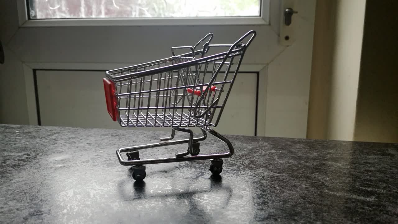 Mini empty shopping cart online home supermarket concept copy space closeup dolly left shot