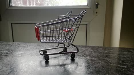 mini empty shopping cart online home supermarket concept copy space closeup dolly left shot