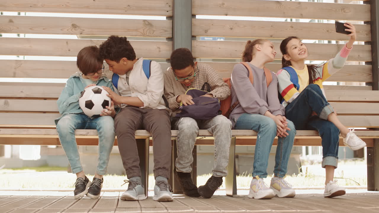 School Children Sitting on Bench Outdoors