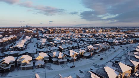 Aerial-view-of-a-suburban-community-at-sunset-in-Calgary,-Alberta-in-winter