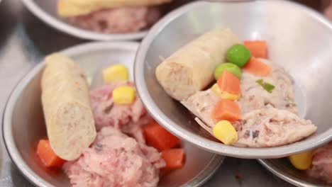 a close-up view of dim sum dishes being prepared, showcasing vibrant ingredients in a bustling phuket market setting