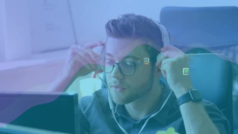 animation of network of connections and media icons over businessman at desk using computer