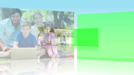 padres e hijos usando computadoras portátiles juntos en un parque