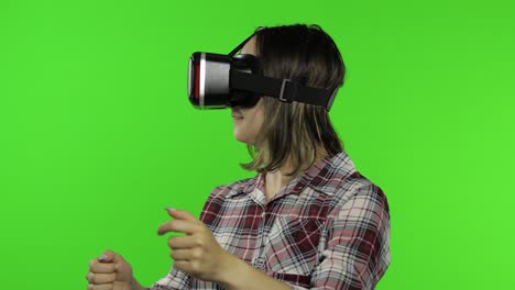 woman using vr headset helmet to play racing game. watching virtual reality 3d 360 video. chroma key