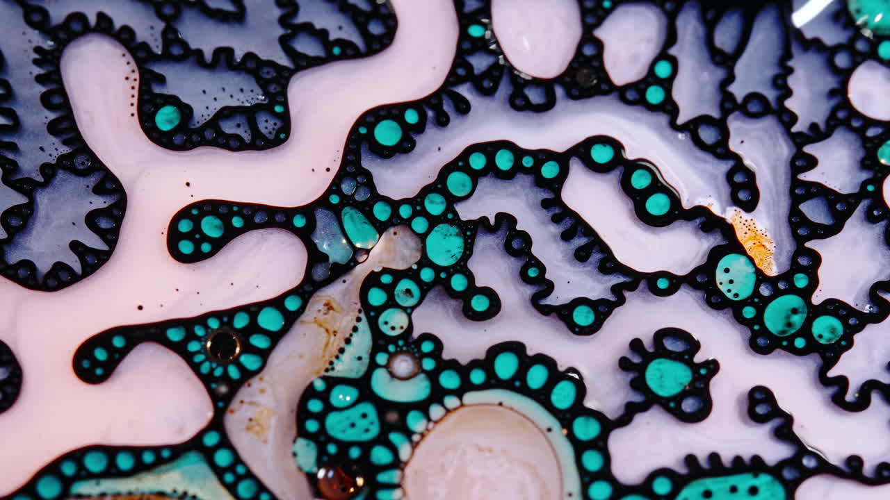 Colorful liquids mixing and swirling in close-up, abstract flow and vibrant patterns