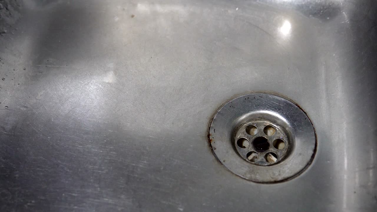 Kitchen sink with water drop dripping, background loop