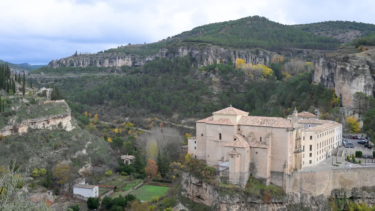 Wide view of the former Convent of San Pablo in Cuenca, Spain, now a luxury Parador hotel. This historic building offers a unique stay perched high above the Huécar gorge.