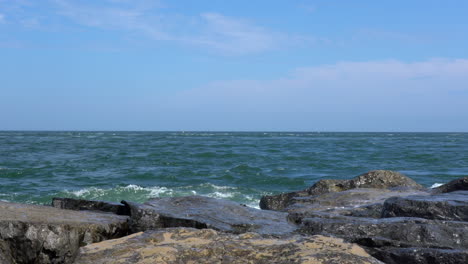 the waves from the ocean breaking over the rocks on the shore