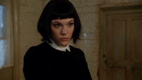 Woman in a black sweater and bob cut