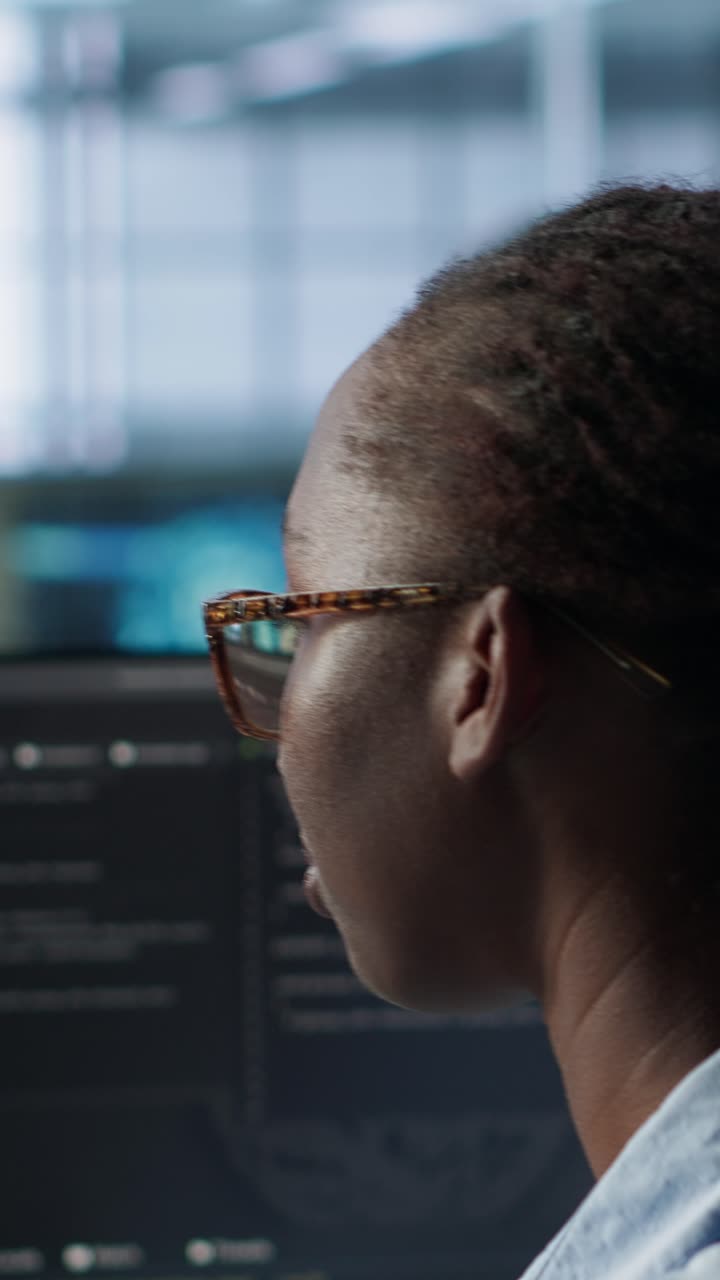 African American Woman Coding on Computer in Modern Office