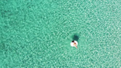 Drone-rotation-over-an-inflatable-alpaca-in-the-crystal-clear-water-of-Salento