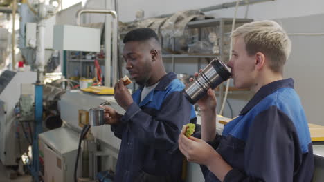 plant workers eating lunch in workplace