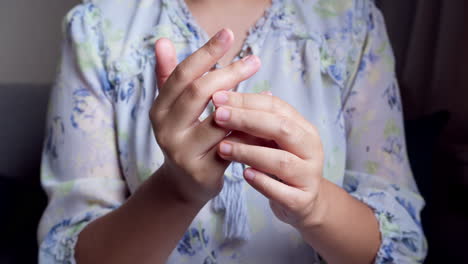 women doing hands stretching and exercising to protect office syndrome and hand arthritis after work at home office day