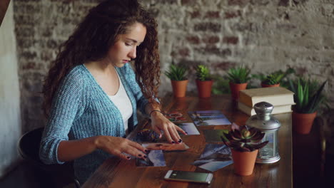 woman arranging and viewing photos