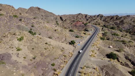 aerial view of vehicle driving along winding rcd road through balochistan