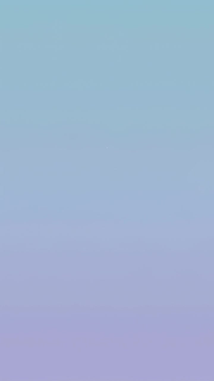 Vertical video: Animating band pulsing, fading, reforming on pastel backdrop to shimmer with pixels