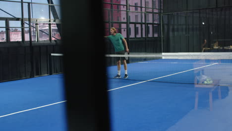 women playing padel tennis on indoor court, focusing on competitive match