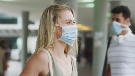 Side-view-of-Caucasian-people-on-the-go-wearing-a-coronavirus-covid19-mask