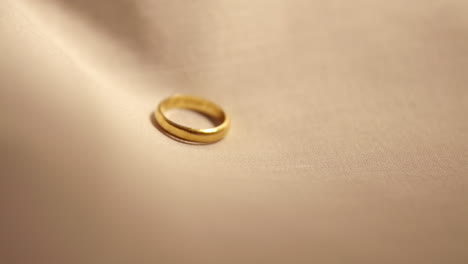 Detail-of-gold-wedding-ring-on-fabric---Slow-motion