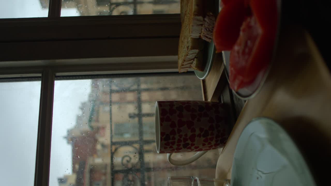 Woman Breakfast by the Window with warm mug cup Bread and Tomatoes on the Table Vertical Video