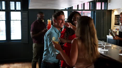 Group-Of-Young-Friends-Meeting-For-Drinks-In-Cocktail-Bar