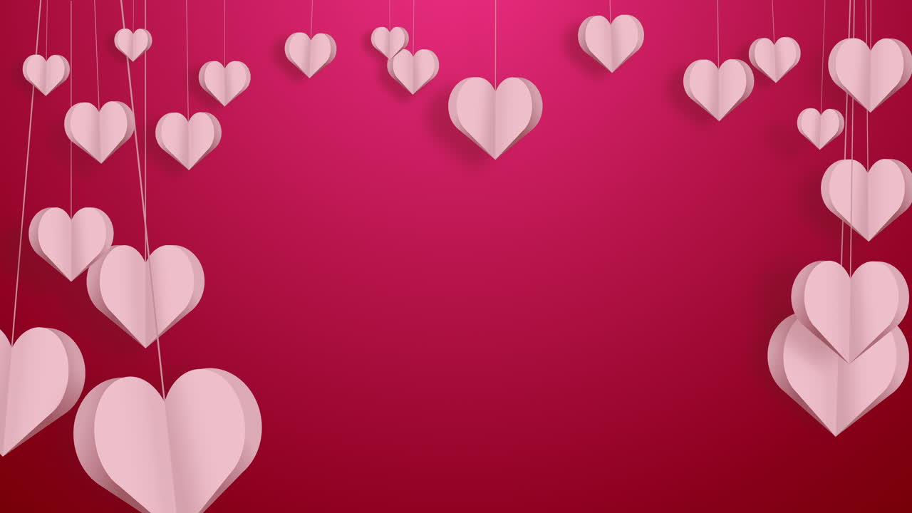 Pink paper hearts on strings sway in the wind. Love romantic red background. Frame with empty space for text.
