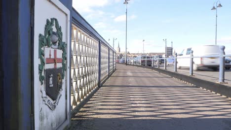 city bridge with coat of arms and passing cars