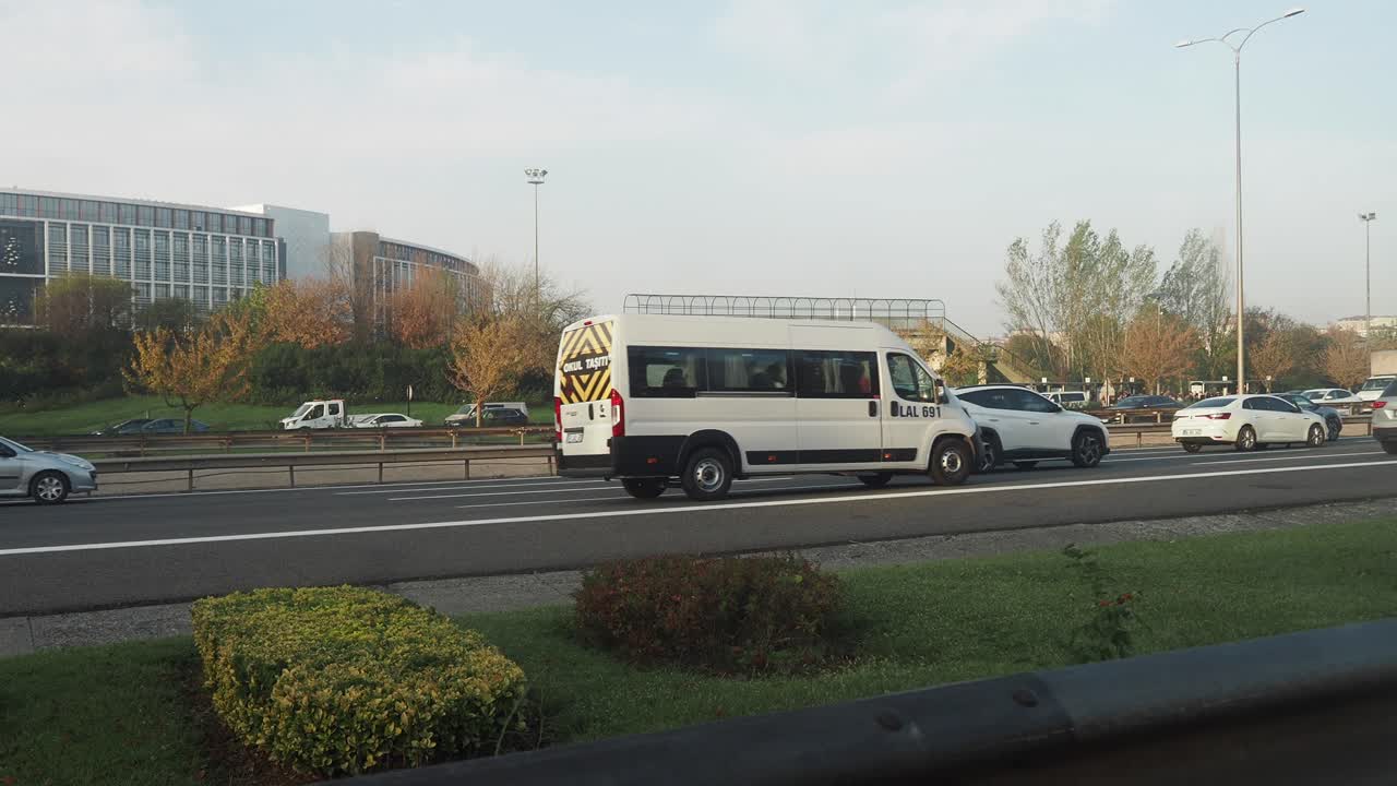 Coches circulando por una carretera en una ciudad.