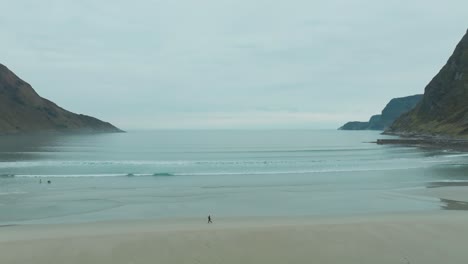 surfer running on beach in hoddevik norway