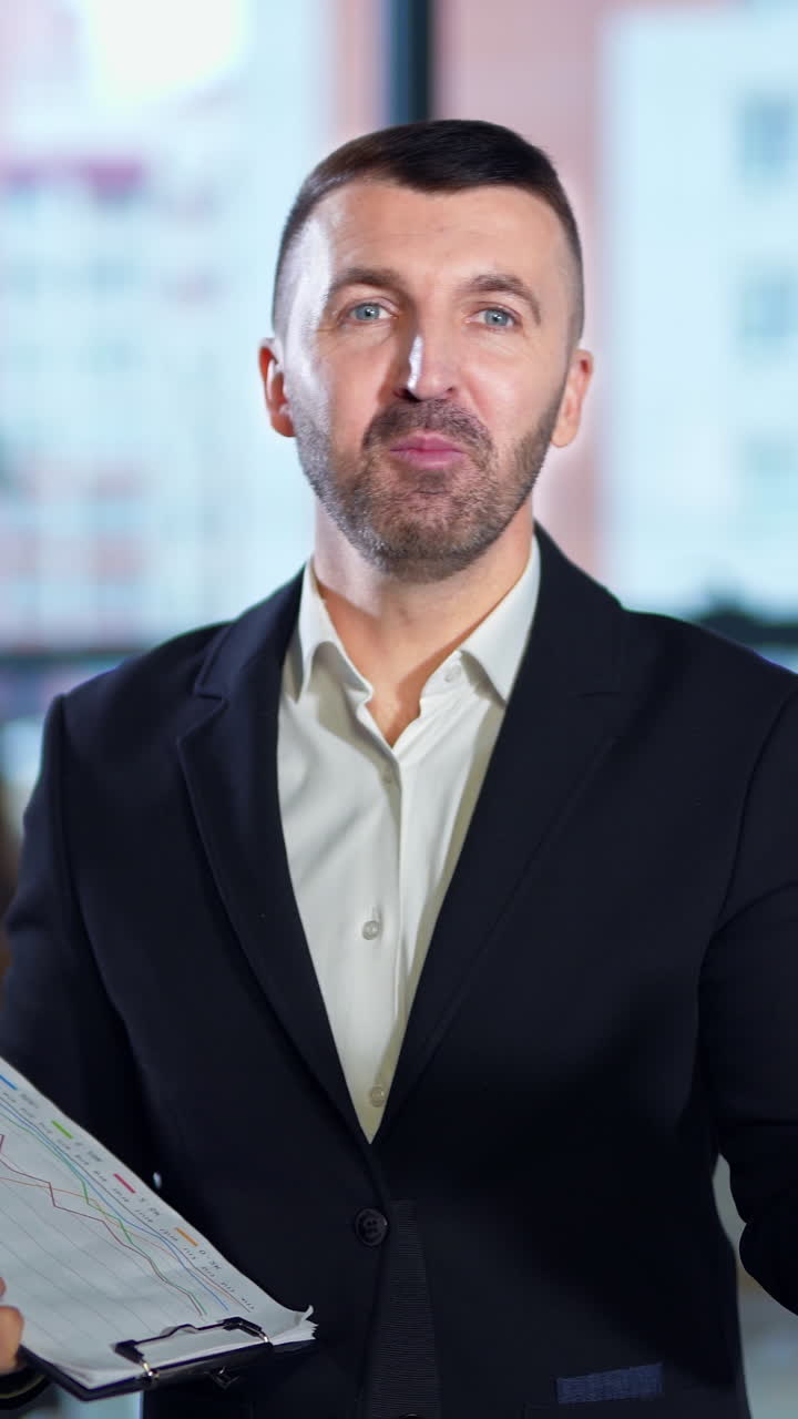 Handsome office worker working with smartphone. Confident young businessman have a phone call. Vertical video