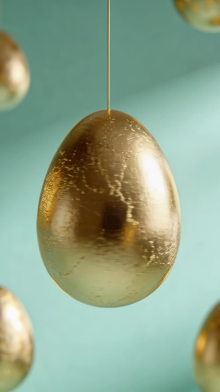 Vertical video: Rotating main golden egg after rod sway in studio close-up showing goldleaf cracks