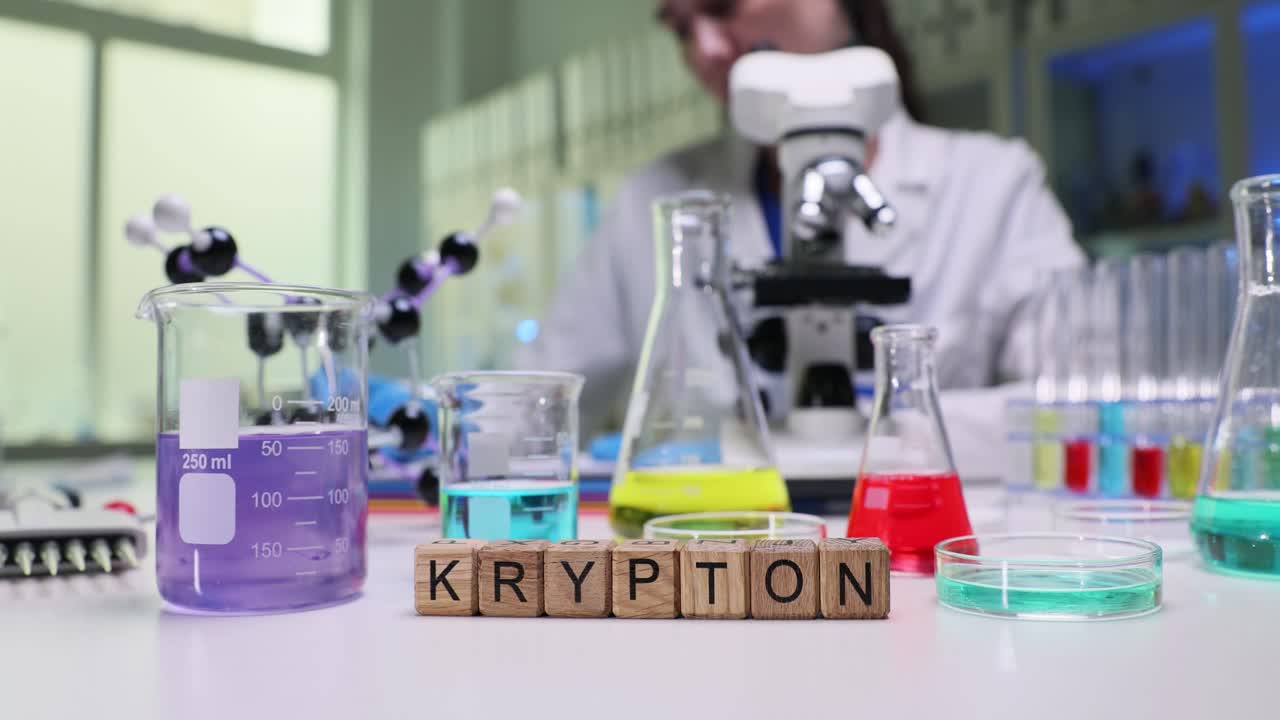 Laboratory setting with Krypton spelled out and a scientist working