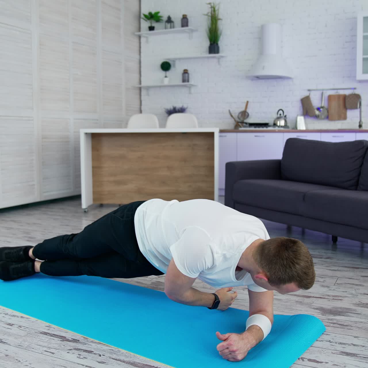 Healthy strong man training indoor. Quarantine working out in home