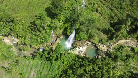 taking off over on an amazing waterfall in the wilderness of the philippines