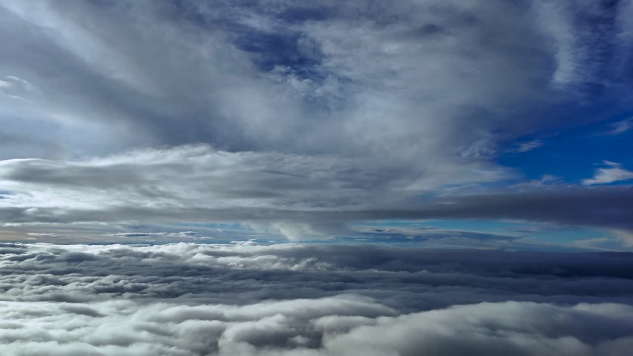 An immeraive pilot’s perspective from a jet cockpit flying at supersonic speed between layers of stratus ethereal clouds in a deep blue sky. Ultra-realistic shot
