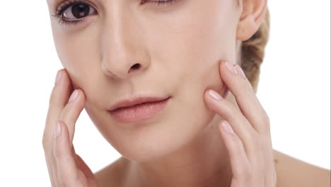 beauty portrait of woman touching beautiful face in slow motion skincare concept on a white background