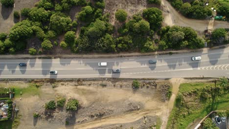 Rising-drone-shot-of-Spain's-highway-cutting-through-the-Tarifa-countryside