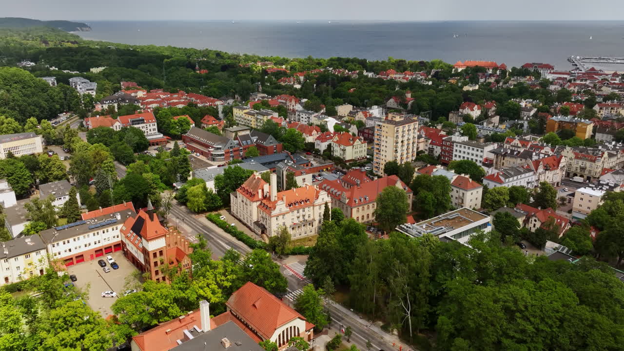 Aerial view of a bird flying over the cityscape of Sopot, summer day in Poland