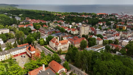 aerial view of a bird flying over the cityscape of sopot, summer day in poland