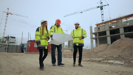 la arquitecta capataz y el ingeniero civil están viendo el plan del sitio de construcción