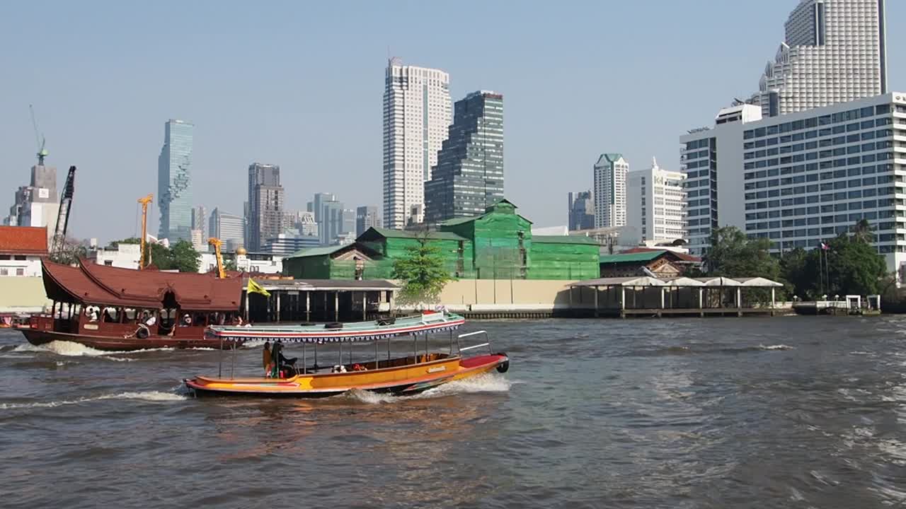 Bangkok City view from the Boat cruise on river Chao Phraya in front of Icon Siam mall - with buildings in front, MahaNakhon tower, Thailand