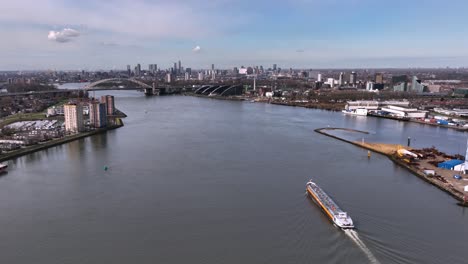 Skyline-of-Rotterdam,-with-the-Van-Brienenoord-bridge-in-the-Background,-Beautiful-Wide-Angle-Aerial-Shot,-Sunny-Day