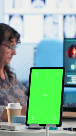 vertical video old general practitioner consulting a female patient next to chroma key space