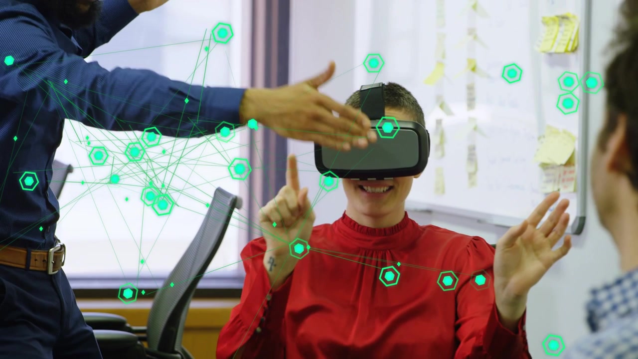 Seated woman in VR headset raising right hand, activating hex overlay, selecting nodes in tech demo