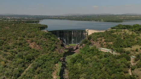 drone dolly zoom - flying over a dam wall birds eye view down