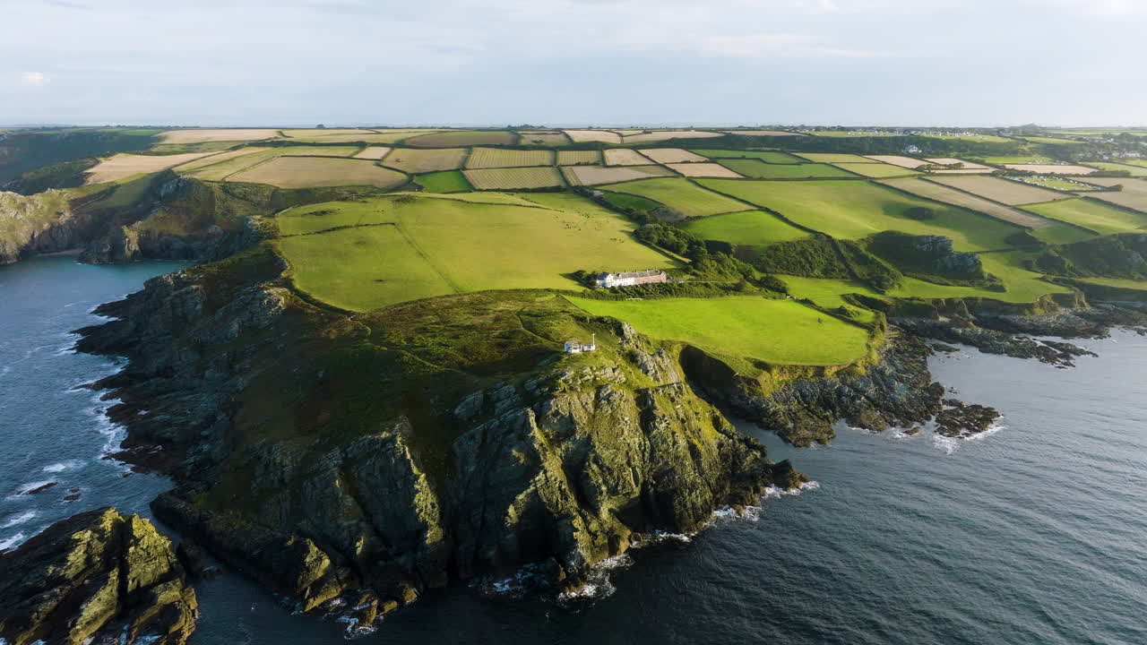 Aerial View of Coastal Landscape with Farmland and Lighthouse