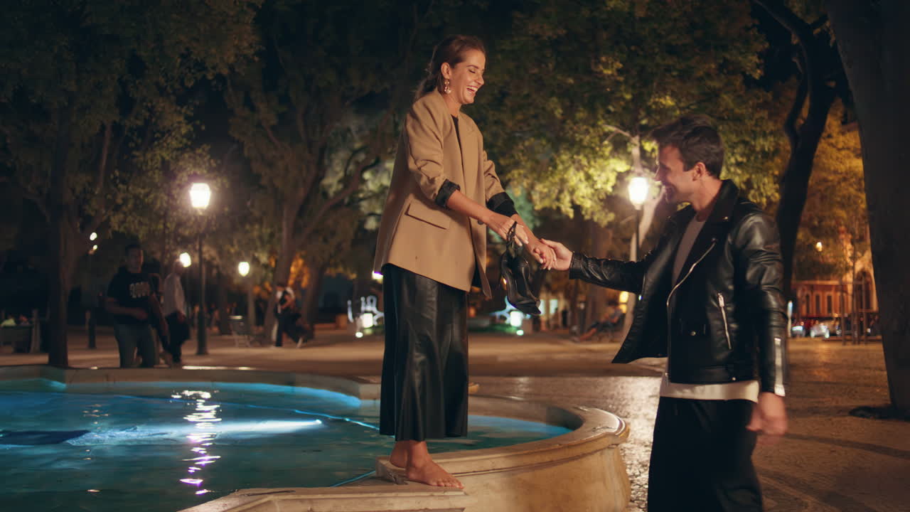 Amorous couple having fun enjoying city date. Affectionate happy people laughing